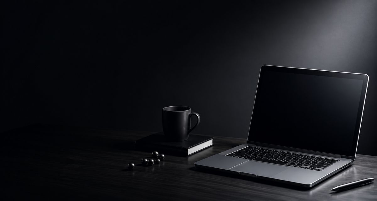 Laptop and coffee on a dark desk